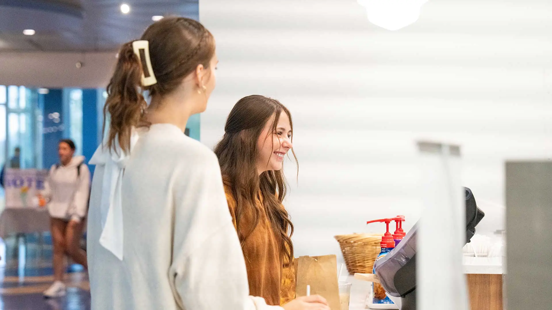 Two students waiting for coffee order