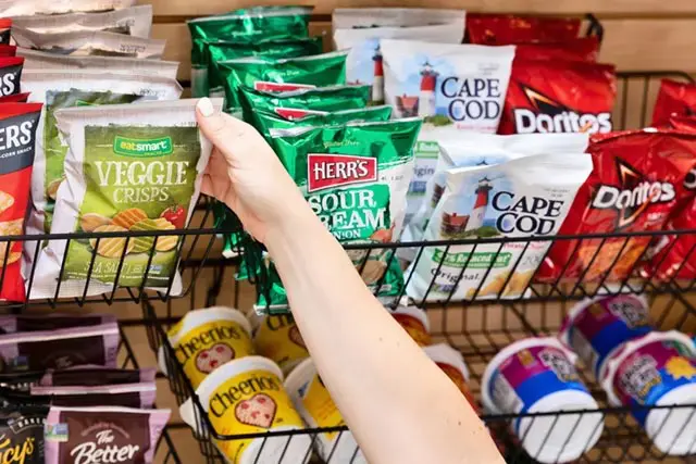Hand grabbing a bag of chips