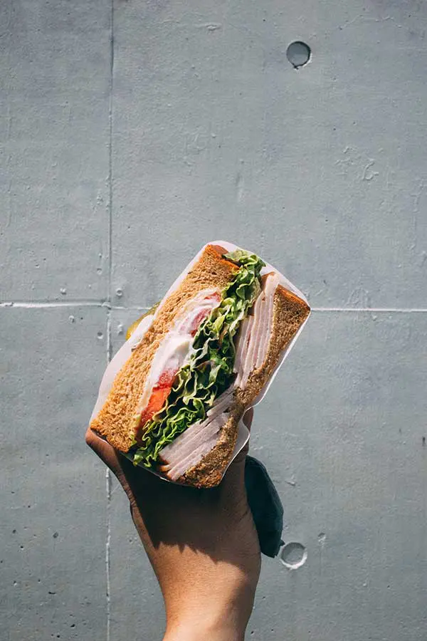Overhead shot of hand holding sandwich