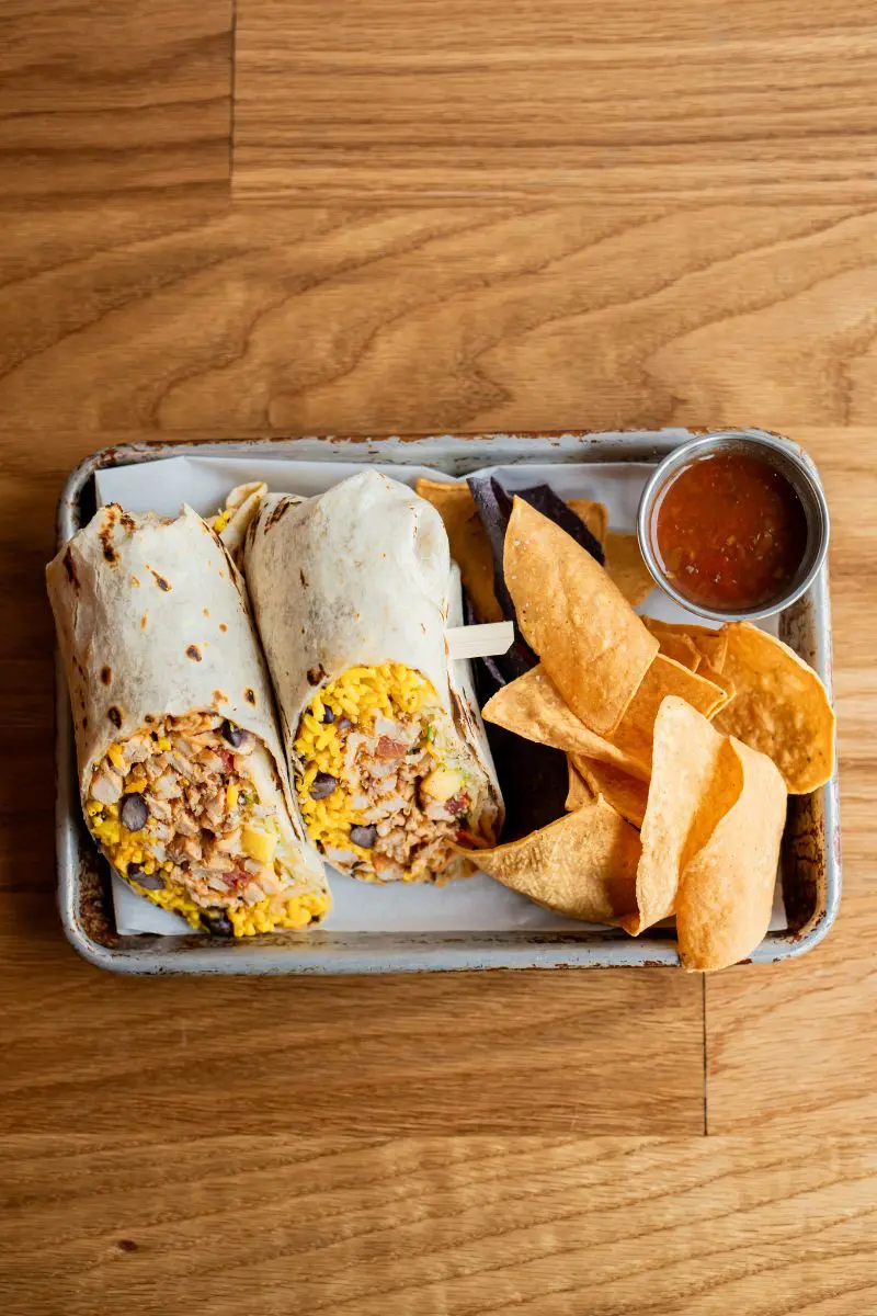 overhead image of al pastor burrito and chips