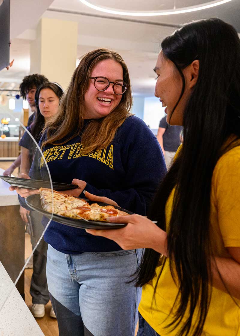 Two students sitting at a table enjoying a meal