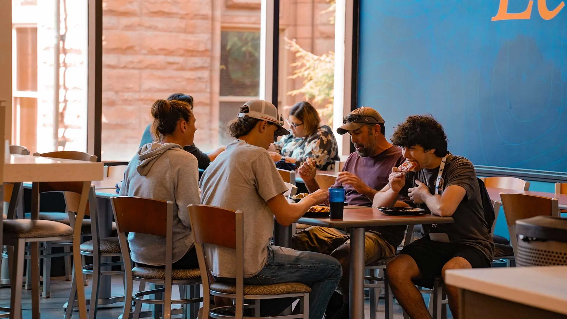Students happily sitting around a table outside